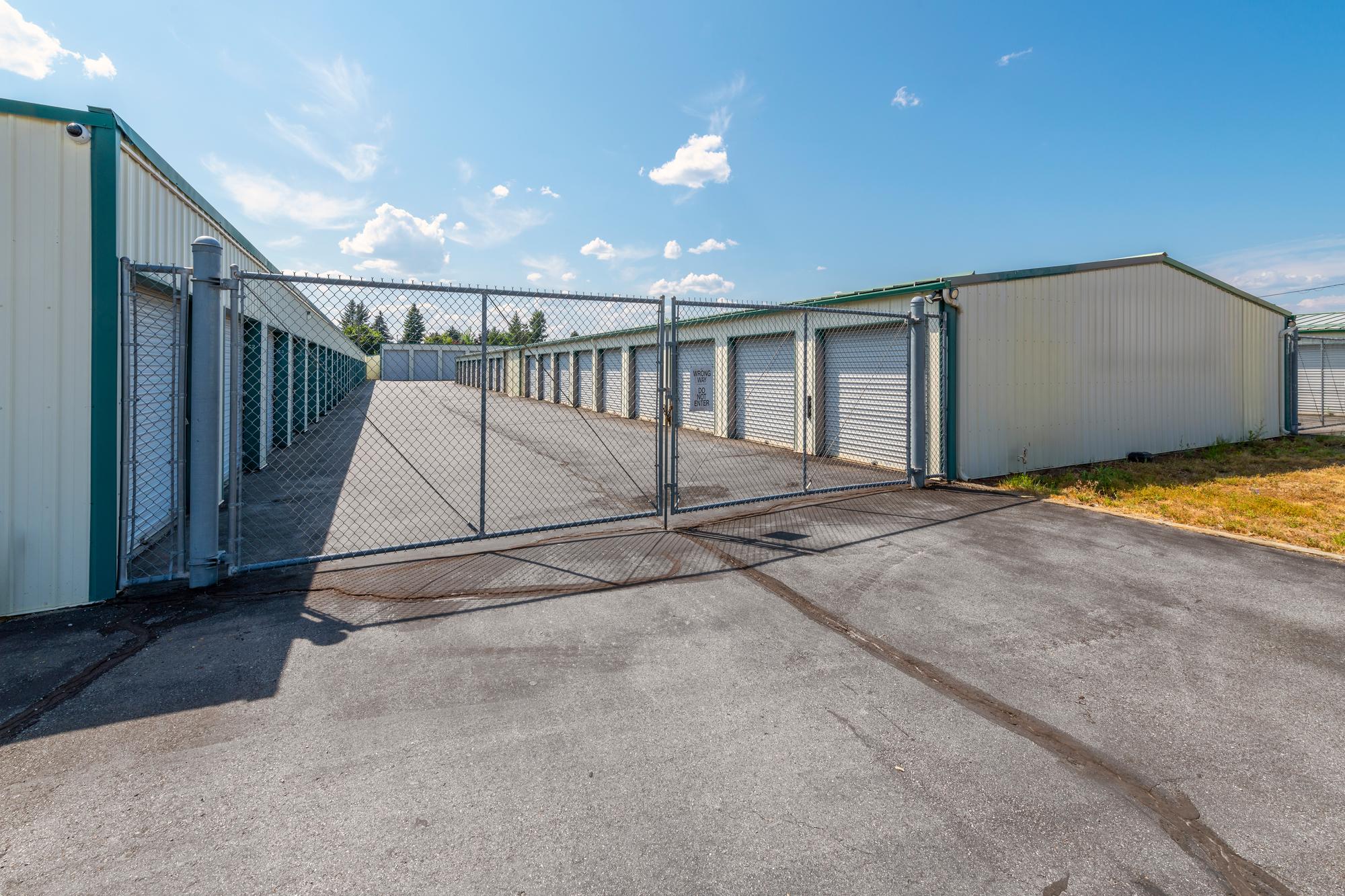 Chain link security fence and rolling gate at a self-storage facility installed by Warrior Barriers
